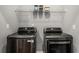 Laundry room features new stainless steel washer and dryer set at 3876 Elm Trace Ct, Loganville, GA 30052