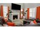 Cozy living room with a fireplace, comfortable seating, large TV, and bright accents for a relaxing atmosphere at 3876 Elm Trace Ct, Loganville, GA 30052