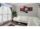Comfortable living room with white sofa, large window, and contemporary decor at 3876 Elm Trace Ct, Loganville, GA 30052