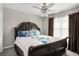 Bedroom features a wooden frame bed and natural light at 3876 Elm Trace Ct, Loganville, GA 30052
