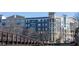 Beautiful exterior view of an apartment building with balconies and pedestrian bridge at 390 17Th Nw St # 2025, Atlanta, GA 30363