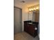 Well lit bathroom featuring a single sink, dark cabinets, and neutral wall paint at 390 17Th Nw St # 2025, Atlanta, GA 30363