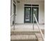 Exterior view of front door with for sale sign, accessible by brick steps at 390 17Th Nw St # 2025, Atlanta, GA 30363