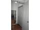 Hallway view featuring a door and decoratively framed mirror on a wood floor at 390 17Th Nw St # 2025, Atlanta, GA 30363