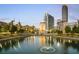 Scenic pond view showcasing fountain, arch, and surrounding city buildings at 390 17Th Nw St # 2025, Atlanta, GA 30363
