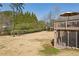 View of the backyard with deck, patio, screened in porch, play set, and mature trees at 2298 Greenglade Ne Rd, Atlanta, GA 30345