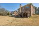Large brick home exterior featuring a spacious backyard, deck, and a covered porch at 2298 Greenglade Ne Rd, Atlanta, GA 30345
