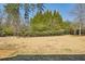 Spacious backyard with lush lawn, mature trees, and swing set, perfect for outdoor recreation and relaxation at 2298 Greenglade Ne Rd, Atlanta, GA 30345