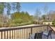 A backyard view from the deck featuring a well maintained yard, mature trees, and lounge chairs at 2298 Greenglade Ne Rd, Atlanta, GA 30345
