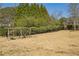 Expansive backyard featuring mature trees, lush greenery, and a swing set for recreation and enjoyment at 2298 Greenglade Ne Rd, Atlanta, GA 30345