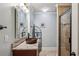 Charming bathroom featuring decorative mirror, stylish vanity with vessel sink, and glass door shower at 2298 Greenglade Ne Rd, Atlanta, GA 30345
