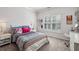 Bedroom with a white bed, neutral walls, and a window with plantation shutters at 2298 Greenglade Ne Rd, Atlanta, GA 30345