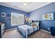 Blue bedroom with a queen-size bed, natural light, and decor at 2298 Greenglade Ne Rd, Atlanta, GA 30345