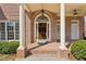 Inviting front porch with brick columns and a classic wooden door at 2298 Greenglade Ne Rd, Atlanta, GA 30345