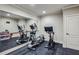 Home gym featuring mirrored wall, stationary bike, elliptical and rubber flooring, ideal for workouts at 2298 Greenglade Ne Rd, Atlanta, GA 30345
