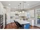 Bright kitchen with white cabinets, a blue island, and stainless steel appliances at 2298 Greenglade Ne Rd, Atlanta, GA 30345