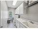 Laundry room with white cabinets, patterned floors, and modern washer and dryer at 2298 Greenglade Ne Rd, Atlanta, GA 30345