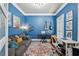 Vibrant living room with blue walls, a cozy couch, and musical instruments at 2298 Greenglade Ne Rd, Atlanta, GA 30345
