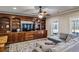 Cozy living room featuring custom built-in shelving, a ceiling fan, a patterned rug and comfortable seating at 2298 Greenglade Ne Rd, Atlanta, GA 30345
