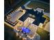 Aerial view of luxury home at dusk featuring extensive hardscape, landscape lighting and large backyard pool at 4100 Oak Hill Rd, Douglasville, GA 30135