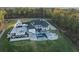 Aerial view of a luxurious estate with a pool, expansive lawn, and mature trees at 4100 Oak Hill Rd, Douglasville, GA 30135
