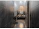Modern bathroom featuring sleek gray tile, a marble vanity, and an elegant chandelier at 4100 Oak Hill Rd, Douglasville, GA 30135