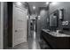 Hallway view of a bathroom featuring dark walls, granite countertop and decorative vanity lighting at 4100 Oak Hill Rd, Douglasville, GA 30135