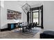 Bright dining room with black table, rug, and trim accents creating a stunning contrast at 4100 Oak Hill Rd, Douglasville, GA 30135