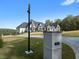 Elegant two-story home with a lush front yard and professionally landscaped surroundings, showcasing luxury living at 4100 Oak Hill Rd, Douglasville, GA 30135