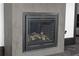 Close-up of a modern gas fireplace set into a gray concrete wall, creating a cozy ambiance at 4100 Oak Hill Rd, Douglasville, GA 30135
