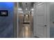 Long hallway with tile floor and a distant view of a modern vanity area with luxury lighting at 4100 Oak Hill Rd, Douglasville, GA 30135