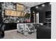 Modern kitchen with black cabinets, marble countertops, stainless steel hood, and luxury finishes at 4100 Oak Hill Rd, Douglasville, GA 30135