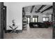 Open-concept living space flowing into a modern kitchen with black accents, herringbone floors, and archways at 4100 Oak Hill Rd, Douglasville, GA 30135