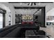 Open-concept living room with modern kitchen, large sectional sofa, and black accents at 4100 Oak Hill Rd, Douglasville, GA 30135