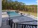 Backyard pool featuring stone paver patio, integrated spa and fire features, overlooking a wooded backyard at 4100 Oak Hill Rd, Douglasville, GA 30135