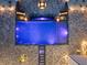 Aerial view of a backyard pool with integrated spa and fire features surrounded by stone paver patio and landscape lighting at 4100 Oak Hill Rd, Douglasville, GA 30135