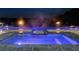 Inviting outdoor pool with luxurious stonework and fire features creates an ambient backyard retreat at 4100 Oak Hill Rd, Douglasville, GA 30135