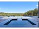 Luxury pool area with lush landscaping, serene water features, and a picturesque wooded backdrop at 4100 Oak Hill Rd, Douglasville, GA 30135
