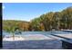 Outdoor pool with stone tiled patio and mature trees surrounding the property at 4100 Oak Hill Rd, Douglasville, GA 30135
