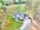 Aerial view showcasing the home's gray roof, well-manicured lawn, and long driveway at 4539 Tiffany Ln, Loganville, GA 30052