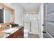 Bathroom featuring a shower stall, granite counter, and wood cabinets at 4539 Tiffany Ln, Loganville, GA 30052
