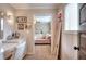 Bathroom featuring a vanity, mirror, sconces, and doorway to bedroom at 4539 Tiffany Ln, Loganville, GA 30052