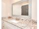 Bathroom vanity with white cabinetry, granite countertop, and decorative mirror at 4539 Tiffany Ln, Loganville, GA 30052