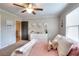 Bright bedroom features a ceiling fan, lots of light, and tasteful decor at 4539 Tiffany Ln, Loganville, GA 30052