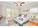 Well-lit bedroom features a plush bed, hardwood floors, and natural light at 4539 Tiffany Ln, Loganville, GA 30052