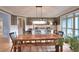 Elegant dining room featuring a long wooden table, bench seating and large bright windows at 4539 Tiffany Ln, Loganville, GA 30052