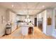 Bright kitchen featuring an island with seating, stainless steel appliances and stone countertops at 4539 Tiffany Ln, Loganville, GA 30052