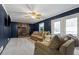 Cozy living room with dark blue paneled walls, brick fireplace with insert and carpet flooring at 5129 Valley Forge Rd, Stone Mountain, GA 30087