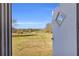 Scenic backyard view through a doorway showcasing a sprawling lawn and lush trees at 8989 E Cherokee Dr, Canton, GA 30115