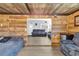 Bedroom featuring wood paneling, comfortable bed, and an open doorway to living area at 8989 E Cherokee Dr, Canton, GA 30115